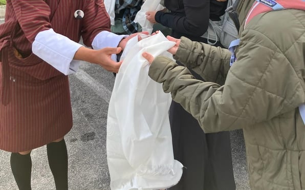 Khata presentation to guest from guide in Bhutan upon arrival to country