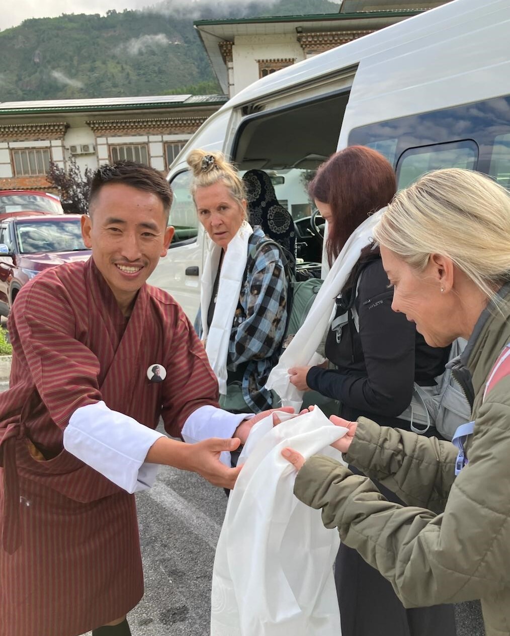 Guide presenting khata to guest